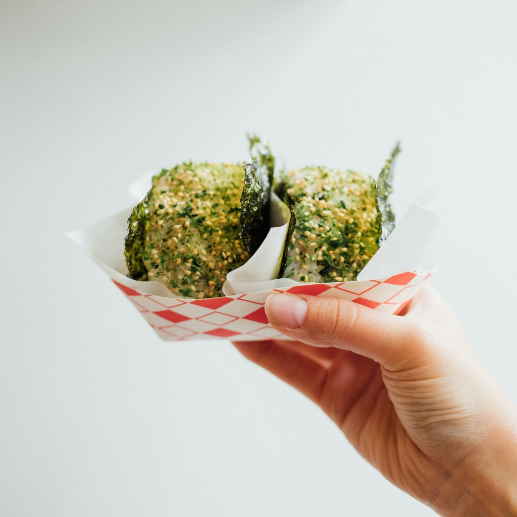 Living well in the 21st century - Limassol, Cyprus. White rice balls wrapped in seaweed, and sesame seeds. 